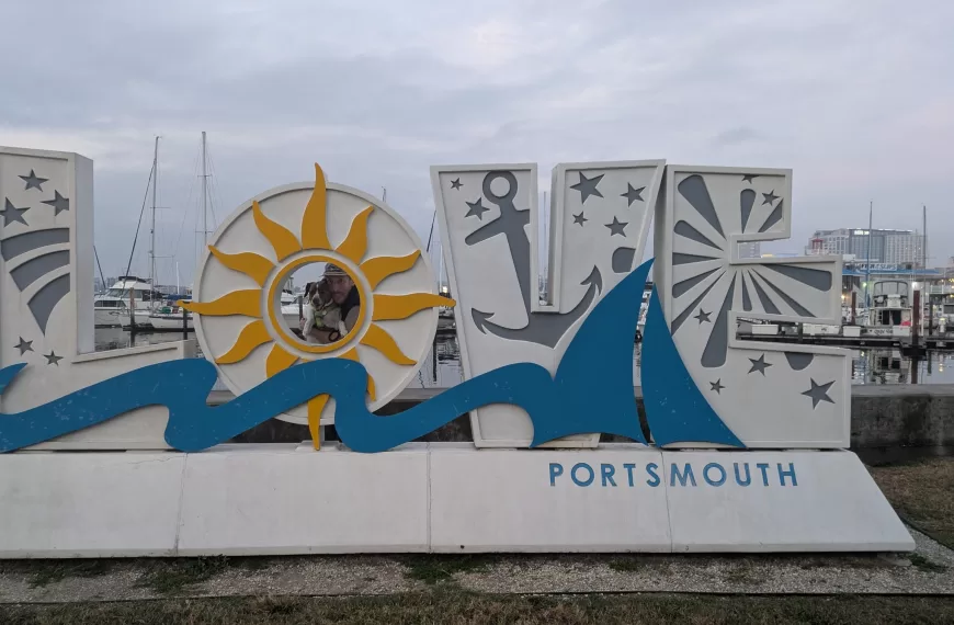 Nic and Kiwi standing behind the "Love Portsmouth" sign in Portmouth, Virginia